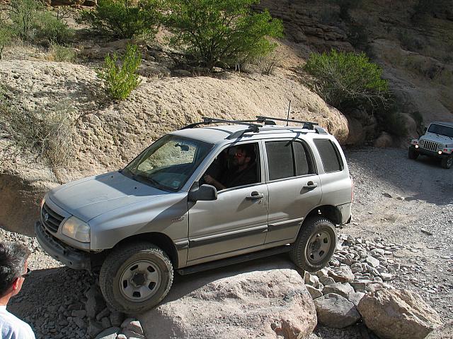 Jeff Scott drives over a rock.
