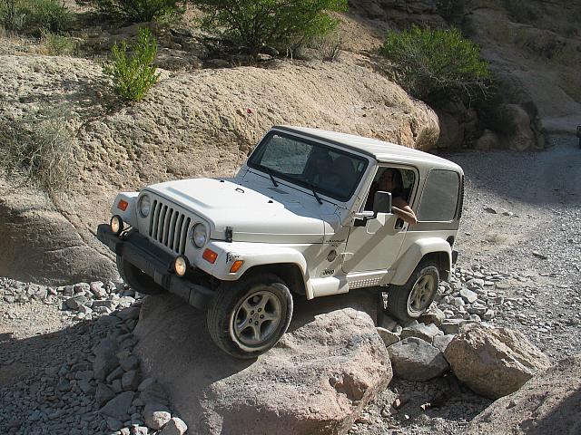 Carl Hoff drives his jeep over a rock in Box Canyon.