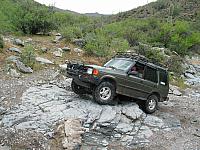 Mike drives over some rocks as we come to the end of Lower Ajax