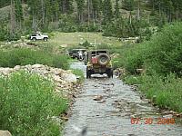 Jay crosses the creek on Half Moon Lake / Iron Mike Mine trip