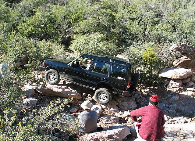 Azim's Discovery climbs a rock.