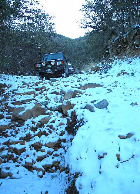 Jon drives over some rocks.