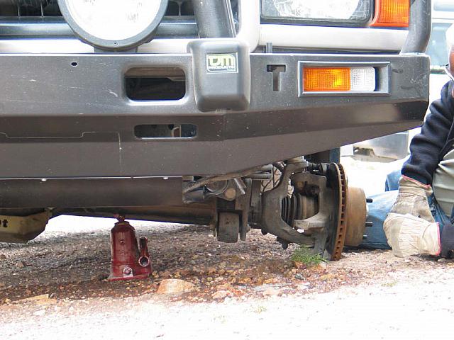 Somebody forgot to chock the tires to keep this truck from falling off the jack.