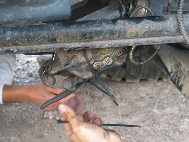 The brake caliper lost a mounting bolt.  It is secured out of the way.