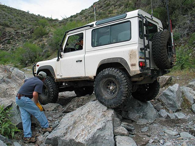 Mike guides Leo over some rocks