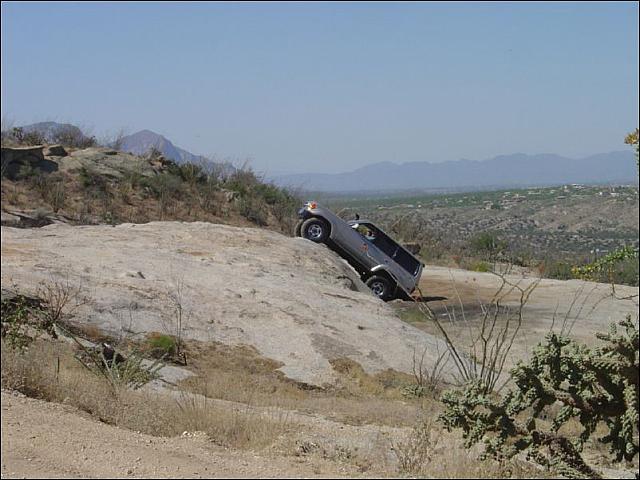 John climbs a rock wall in his Cruiser