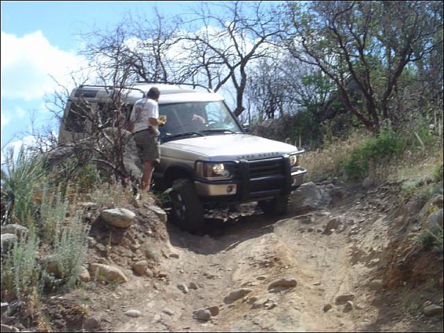 Mike has a discussion with Clay as he squeezes past a rock