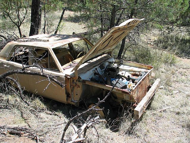 Abandoned car with custom bumper in Sunnyside.