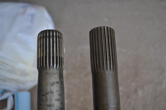 DII front half shaft carrier end - HD replacement vs. stock (left)