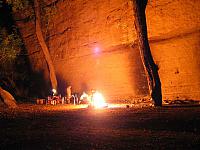 The fire roars as we drink beer and swap stories.