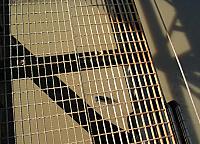 Shadow swims across the river under the bridge