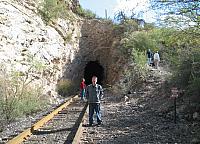 Austin poses in front of a railroad tunnel