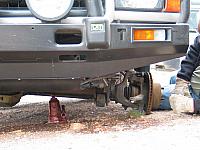 Somebody forgot to chock the tires to keep this truck from falling off the jack.