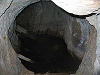 Not far in, the shaft is filled with water.