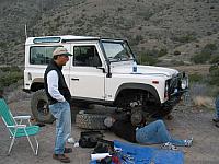 Azim talks to Leo as he secures the brake caliper out of the way.