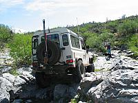Leo drives over the rocks