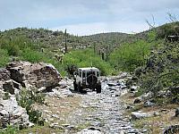 Leo drives down the stream bed