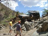 Mike looks out the window before proceeding further