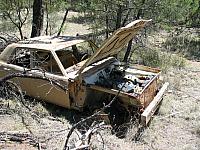 Abandoned car with custom bumper in Sunnyside.