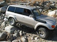 John Shotts drives over a boulder