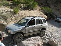 Jeff Scott drives over a rock.