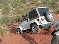 Carl goes down the playhill.